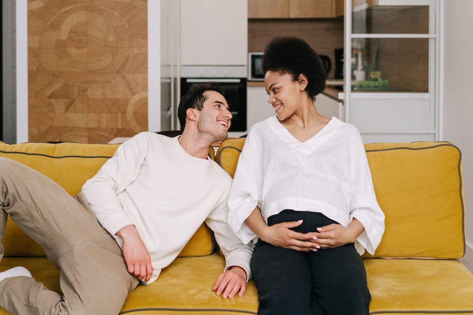 Man and Woman Sitting on Brown Wooden Table